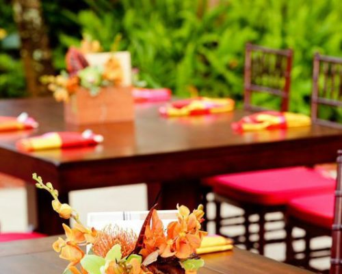 Dark Mahogany trestle table close-up with tropical centerpiece