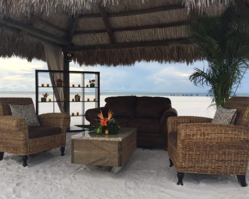 wicker grouping under cabana with brown sofa